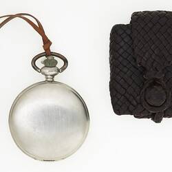 Metal fob watch with braided leather braided pouch.