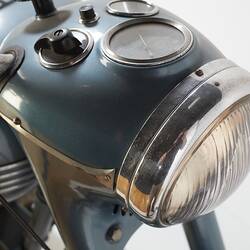 Blue metallic motor cycle. Headlight and dash detail.