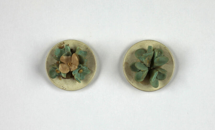 Two toy plates of flowers.