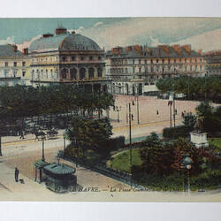 Urban streetscape with buildings and park.