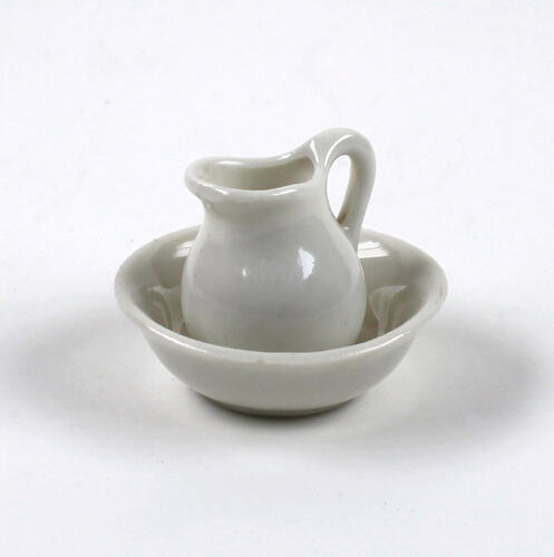 Toy jug in bowl, made of white ceramic.