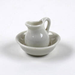 Toy jug in bowl, made of white ceramic.