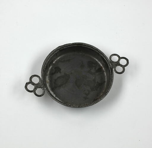 Round toy metal tray with handles.