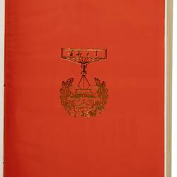 Red page of book with gold outline of commemorative medal.