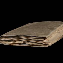 Discoloured book with worn pages.