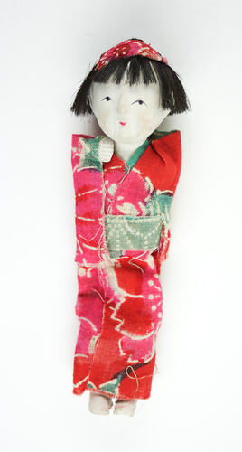 Small Japanese doll in kimono, front side.