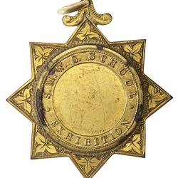 Gold medal set in 8-pointed star with loop. Centre is blank, text around.