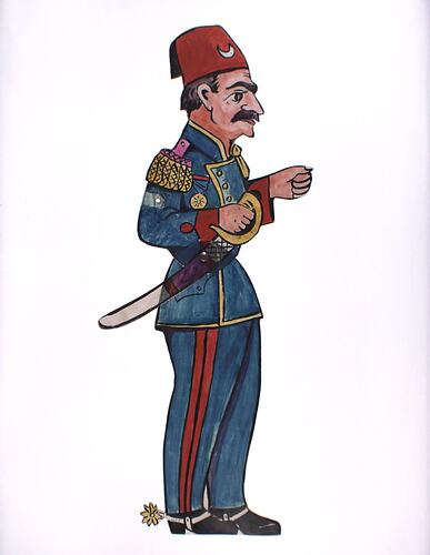 Two dimensional acrylic puppet of a man wearing a blue military uniform and red fez.