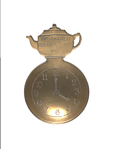 Front of souvenir spoon with teapot shape at top.