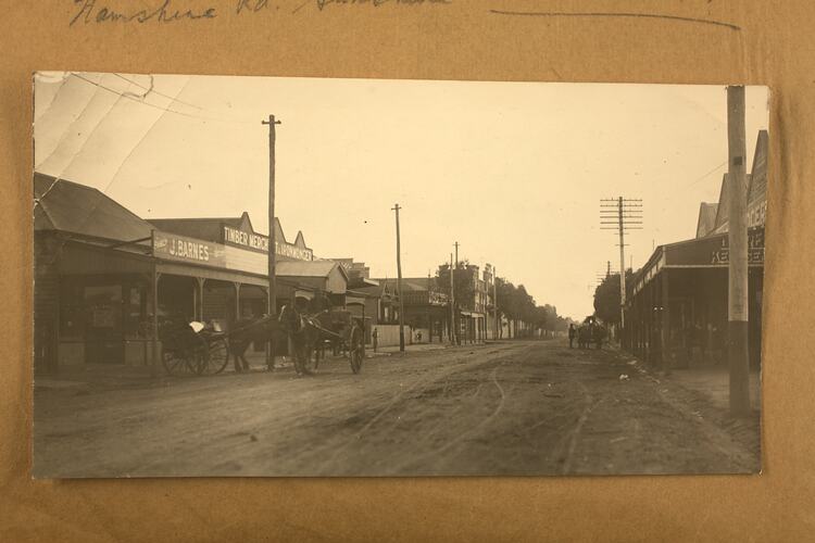 Photograph of streetscene adhered to album page.