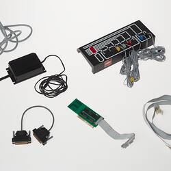 Rectangular black plastic computer control. Also cables and components.