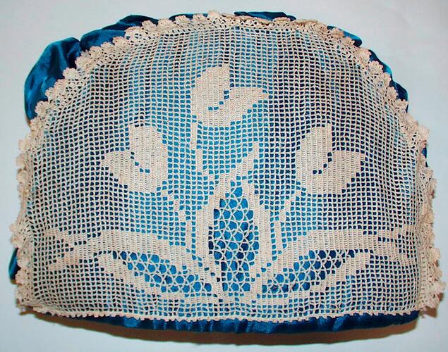 Side view of crochet lace tea cosy.