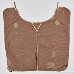 Rectangular woollen horse rug, brown and white check. Brown fastenings and leather straps. Laid flat.