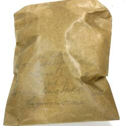 Brown crinkled paper bag with faint text.
