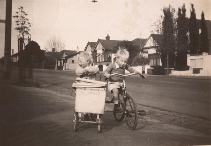 Digital Photograph - Twin Boy & Girl Using Tricycle to Push Pram outside Home, Windsor, circa 1949