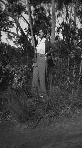 Woman dressed in trousers in bushland.
