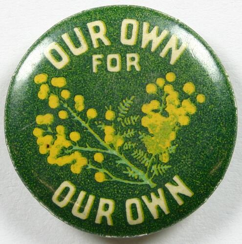 Badge with wattle spray and words on green background.