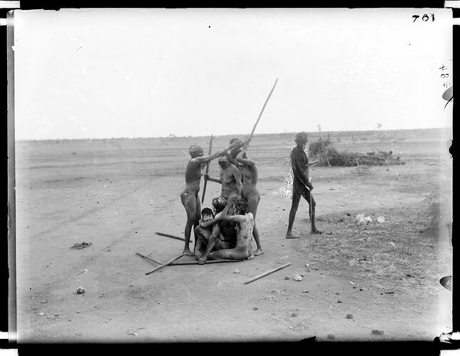 Two widows with cropped hair and covered with white pipe clay sitting under a shelter they built themselves, Tennant Creek, Central Australia, 16-17 August 1901