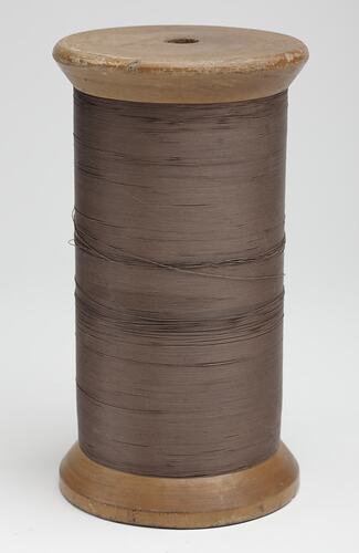 Reel of cotton, brown thread