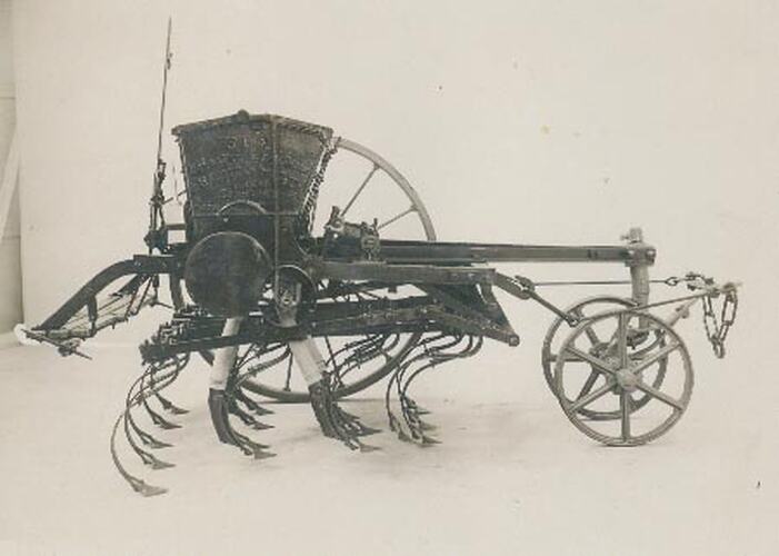 Right hand side studio photograph of a seed and fertilizer drill.