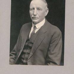 Head and shoulders portrait of man in suit.