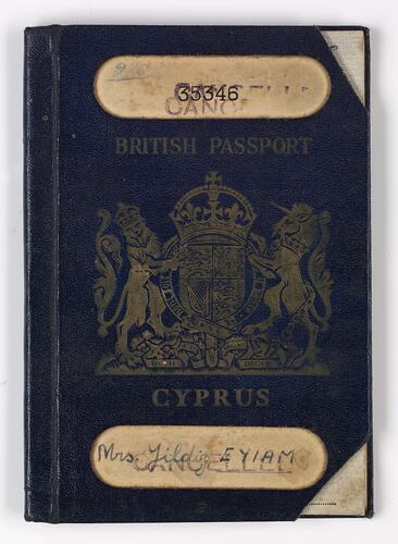 Dark blue passport front cover with gold printing. Logo in centre. Two cut out strips at top and bottom.