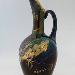 A blue and gold-coloured bronze glass pouring jug.
