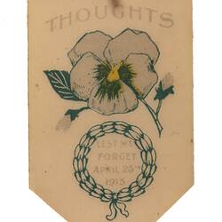 Cream coloured metal badge with image of flower and text.