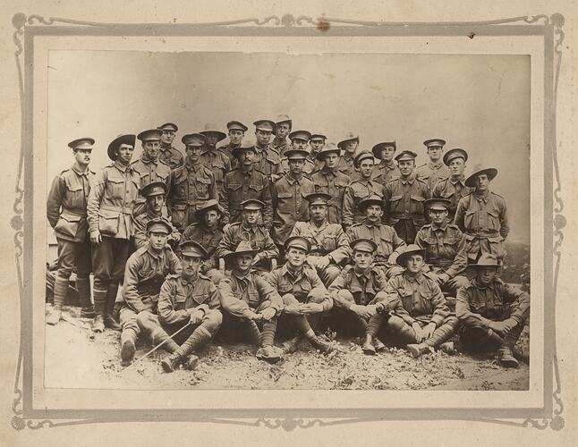 Portrait of 34 WWI Australian soldiers. Some are standing and some are sitting. They are all in uniform.
