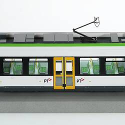 Tram model of green and white articulated, low-floor tram.