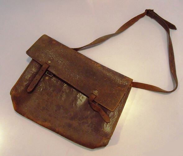 Leather bag with flap and strap