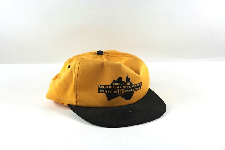 Yellow and black baseball cap with text.
