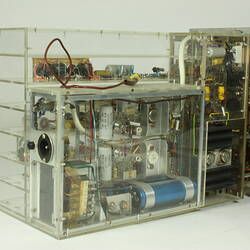 Control box, partially in clear box that shows internal wiring and components.