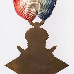 Back of bronze four point star medal 'ensigned' by a crown. Red, white and blue ribbon.