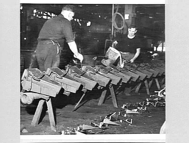 CHILLED CAST SHARE PRODUCTION AT SUNSHINE. BOB MCPHERSON (LEFT) PREPARES TO KNOCK-OUT THE CHILL MOULDS AFTER TOM RIGBY HAS POURED THE MOULTEN METAL INTO THEM.