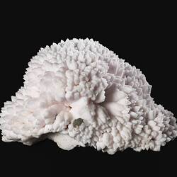 Pale pink mineral specimen.