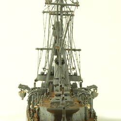 Naval ship with two masts, rear view.