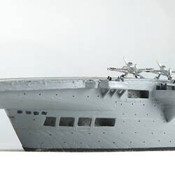 Naval ship with five aeroplanes on deck, detail of stern.