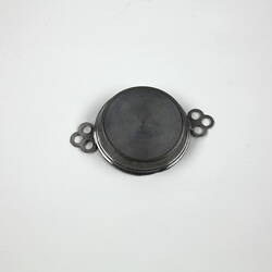 Reverse of round toy metal tray.