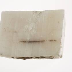 White, flat, sheet-like mineral.