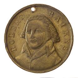 Round bronze medal with three-quarter bust of male facing left. Text around.