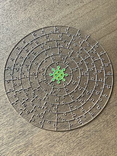 Completed clear virus puzzle on table.