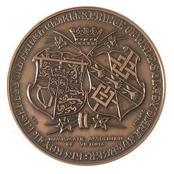 Round medal, crown and two daffodils above British Royal shield and Spencer shield. Text below, around.