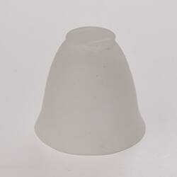 Opaque glass bell-shaped cup. Upside down with narrower base at top.