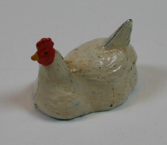Toy metal white chicken with red comb and wattle.