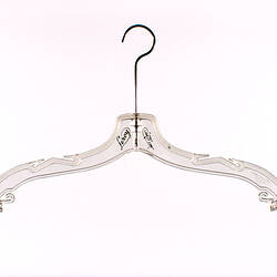 Clear plastic coat hanger with metal hook.