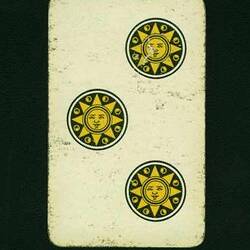 Back of a playing card with three suns.
