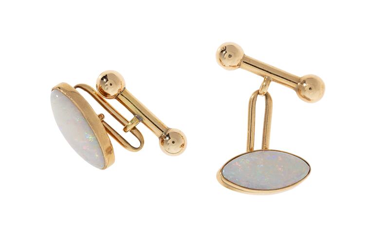 Gold clip cufflinks, each with an oval white opal.