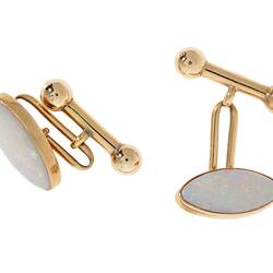 Gold clip cufflinks, each with an oval white opal.