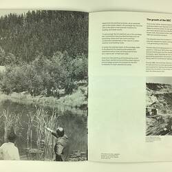 Open booklet. Black and white image of a pine plantation and a pond.
